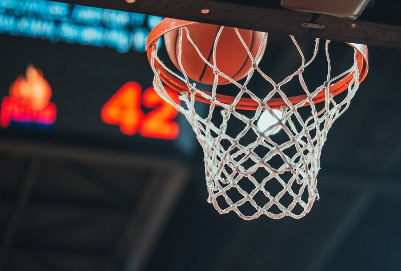 Basketball about to go through the hoop